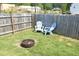 Backyard space featuring a fire pit area with comfortable seating, ideal for outdoor relaxation and entertaining at 39 Principal Way, Clayton, NC 27520