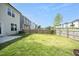 Well-maintained backyard featuring lush green grass and a secure wooden fence for privacy and enjoyment at 39 Principal Way, Clayton, NC 27520