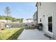 Backyard featuring a well-maintained lawn, concrete patio, a grill and comfortable seating, perfect for outdoor gatherings at 39 Principal Way, Clayton, NC 27520