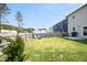Large backyard features lush green grass, a firepit, seating, and fenced perimeter, perfect for outdoor enjoyment at 39 Principal Way, Clayton, NC 27520