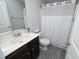 Cozy bathroom featuring a shower and vanity sink, complete with neutral colors and wood look floor at 39 Principal Way, Clayton, NC 27520