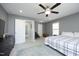 Spacious bedroom featuring neutral walls, carpet, a ceiling fan, and windows with natural light at 39 Principal Way, Clayton, NC 27520