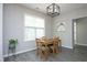 Inviting dining room with a natural wood table set and contemporary light fixture at 39 Principal Way, Clayton, NC 27520