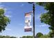 A banner in Downtown Clayton promoting live music and the town's unique atmosphere, against a blue sky at 39 Principal Way, Clayton, NC 27520