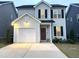 Charming two-story home featuring a driveway, garage, and a welcoming front entrance at 39 Principal Way, Clayton, NC 27520