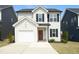 Charming two-story home with white siding, black shutters, covered entrance, and a one-car garage at 39 Principal Way, Clayton, NC 27520