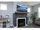 A close-up of a fireplace with a mounted TV, display shelves, and decorative decor at 39 Principal Way, Clayton, NC 27520