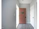 Open foyer showcasing a stylish front door with wreath, gray walls, wood-look floors, and white trim at 39 Principal Way, Clayton, NC 27520