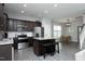 Modern kitchen with stainless steel appliances, granite countertops, and an island with seating at 39 Principal Way, Clayton, NC 27520