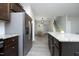 Open kitchen and dining area featuring dark cabinets, stainless appliances, and granite countertops at 39 Principal Way, Clayton, NC 27520