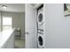 Upstairs laundry area featuring a stacked washer and dryer, maximizing space and convenience at 39 Principal Way, Clayton, NC 27520