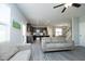 Open-concept living room featuring hardwood floors, comfortable seating, and a seamless flow to the kitchen at 39 Principal Way, Clayton, NC 27520