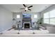 Cozy living room with fireplace, ceiling fan, neutral walls, and comfortable seating for relaxing at 39 Principal Way, Clayton, NC 27520