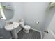 Stylish powder room with a pedestal sink, decorative mirror, and modern fixtures, creating a welcoming space at 39 Principal Way, Clayton, NC 27520