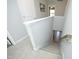 Carpeted staircase with white risers and wooden handrail leading to the lower level of the home at 39 Principal Way, Clayton, NC 27520