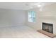Bright living room featuring a cozy fireplace, neutral walls, and a ceiling fan at 403 Gooseneck Dr # A-1, Cary, NC 27513