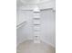 Walk-in closet with white shelving, closet rod, and neutral carpet at 403 Gooseneck Dr # A-1, Cary, NC 27513