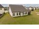 Spacious backyard with well-kept lawn and a covered patio, perfect for outdoor entertaining at 404 Lily Pad Ct, Zebulon, NC 27597