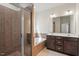 Elegant bathroom with a glass-enclosed shower, soaking tub, and double vanity at 404 Lily Pad Ct, Zebulon, NC 27597