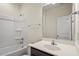 Bathroom with a vanity, mirror, and shower-tub combo, perfect for relaxation and convenience at 404 Lily Pad Ct, Zebulon, NC 27597