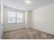 Bedroom with neutral carpet, a window providing natural light, and a closet for storage at 404 Lily Pad Ct, Zebulon, NC 27597