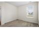 Well-lit bedroom with neutral carpet and a window view at 404 Lily Pad Ct, Zebulon, NC 27597