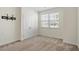 Bedroom features a window, neutral carpet, closet, and ample space at 404 Lily Pad Ct, Zebulon, NC 27597