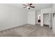 Bright bedroom featuring neutral carpeting, ceiling fan and access to an ensuite bathroom at 404 Lily Pad Ct, Zebulon, NC 27597