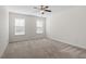 Spacious bedroom with neutral carpet, ceiling fan and ample natural light at 404 Lily Pad Ct, Zebulon, NC 27597