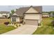 Attractive home with a two-car garage, neat landscaping, and a paved driveway at 404 Lily Pad Ct, Zebulon, NC 27597