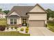 Charming home with stone accents, manicured landscaping, and a two-car garage at 404 Lily Pad Ct, Zebulon, NC 27597