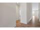 Hallway features wood flooring and neutral walls, providing access to various rooms at 404 Lily Pad Ct, Zebulon, NC 27597