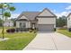 Charming home featuring a 2 car garage, well maintained lawn, and mature landscaping at 404 Lily Pad Ct, Zebulon, NC 27597