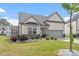 Charming home featuring a 2 car garage, well maintained lawn, and mature landscaping at 404 Lily Pad Ct, Zebulon, NC 27597
