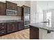 Kitchen featuring granite countertops, wood cabinets, and stainless appliances at 404 Lily Pad Ct, Zebulon, NC 27597