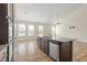 Open concept kitchen with island and granite countertops overlooks the dining and living areas at 404 Lily Pad Ct, Zebulon, NC 27597