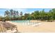 Resort-style community pool featuring a zero entry play area, in addition to lounge chairs and shaded pergolas at 404 Lily Pad Ct, Zebulon, NC 27597