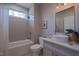 Bright and modern bathroom with a vessel sink, tiled shower and tub and picture frame mirror at 4331 Millcreek Cir, Pittsboro, NC 27312