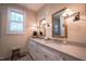Modern bathroom with dual sinks, quartz countertops, and natural lighting from a bright window at 4331 Millcreek Cir, Pittsboro, NC 27312