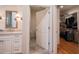 Bright bathroom with white cabinets, marble countertop, walk in closet and neutral tile flooring at 4331 Millcreek Cir, Pittsboro, NC 27312
