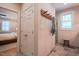 Hallway shot that provides a glimpse of an adjacent bedroom and an attached bathroom with glass-enclosed shower at 4331 Millcreek Cir, Pittsboro, NC 27312