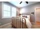 Neutral bedroom with an antique brass bed, ceiling fan, plantation shutters, and hardwood flooring at 4331 Millcreek Cir, Pittsboro, NC 27312