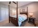 Bedroom with four-poster bed, ceiling fan, hardwood floors, and an ensuite bathroom at 4331 Millcreek Cir, Pittsboro, NC 27312