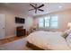 Comfortable bedroom with a ceiling fan, wood floors and a unique stained glass window accent at 4331 Millcreek Cir, Pittsboro, NC 27312