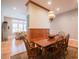 Open-concept dining area flowing into a living room with large windows offering abundant natural light at 4331 Millcreek Cir, Pittsboro, NC 27312