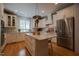 Modern kitchen featuring white cabinets, a center island, stainless steel appliances, and hardwood floors at 4331 Millcreek Cir, Pittsboro, NC 27312