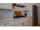 Modern kitchen with stainless steel appliances, white cabinets, subway tile backsplash, and granite countertops at 4331 Millcreek Cir, Pittsboro, NC 27312