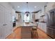 Spacious kitchen with stainless steel appliances, an island, and hardwood floors at 4331 Millcreek Cir, Pittsboro, NC 27312
