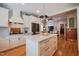 Contemporary kitchen with stainless steel appliances, white cabinets, and open layout to the living area at 4331 Millcreek Cir, Pittsboro, NC 27312