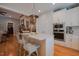 Eat-in kitchen island featuring seating, stone countertop, overhead light fixture, and modern appliances at 4331 Millcreek Cir, Pittsboro, NC 27312